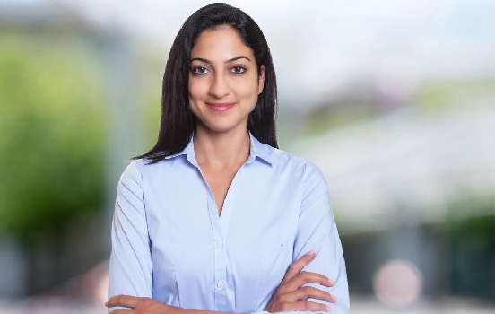 A woman in blue shirt with arms crossed.