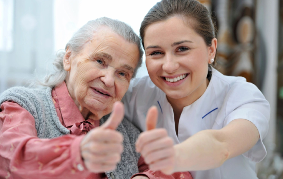 A woman and an old lady giving thumbs up.