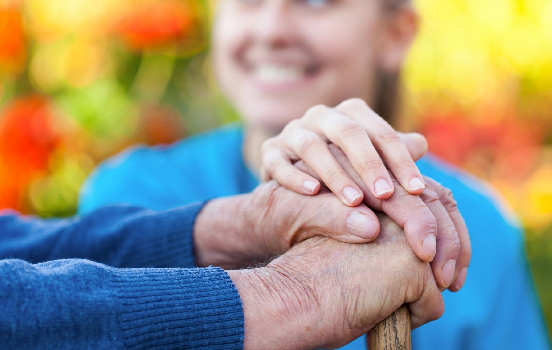 A close up of two people holding hands