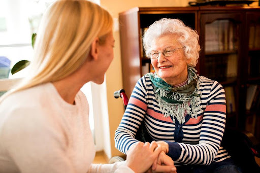 Two woman smiling and chatting.