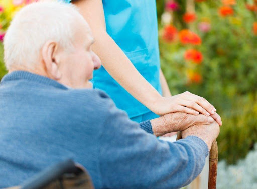 A man holding his hands with another person.