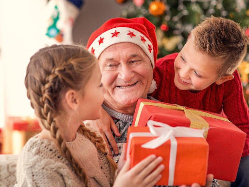 A group of people that are holding gifts